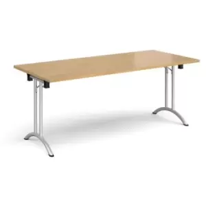 Rectangular folding leg table with silver legs and curved foot rails 1800mm x 800mm - oak