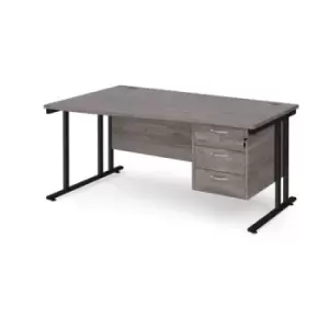 Maestro 25 left hand wave desk 1600mm wide with 3 drawer pedestal - Black cantilever leg frame and grey oak top