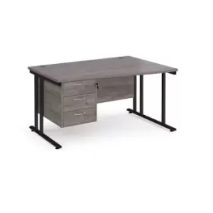 Maestro 25 right hand wave desk 1400mm wide with 3 drawer pedestal - Black cantilever leg frame and grey oak top