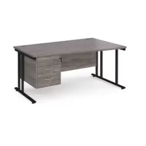 Maestro 25 right hand wave desk 1600mm wide with 3 drawer pedestal - Black cantilever leg frame and grey oak top