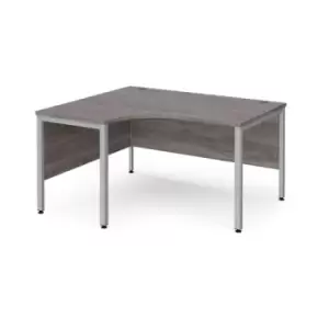 Maestro 25 left hand ergonomic desk 1400mm wide - silver bench leg frame and grey oak top